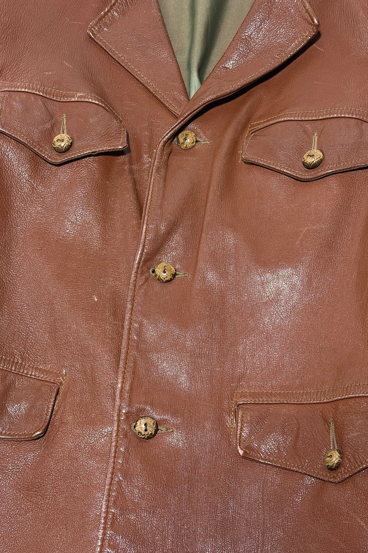 1940's cognac leather sport jacket button and flap pocket detail