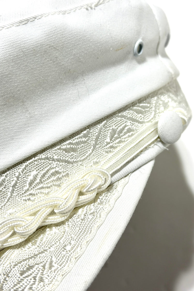 Greek fisherman's cap braided trim and covered button detail
