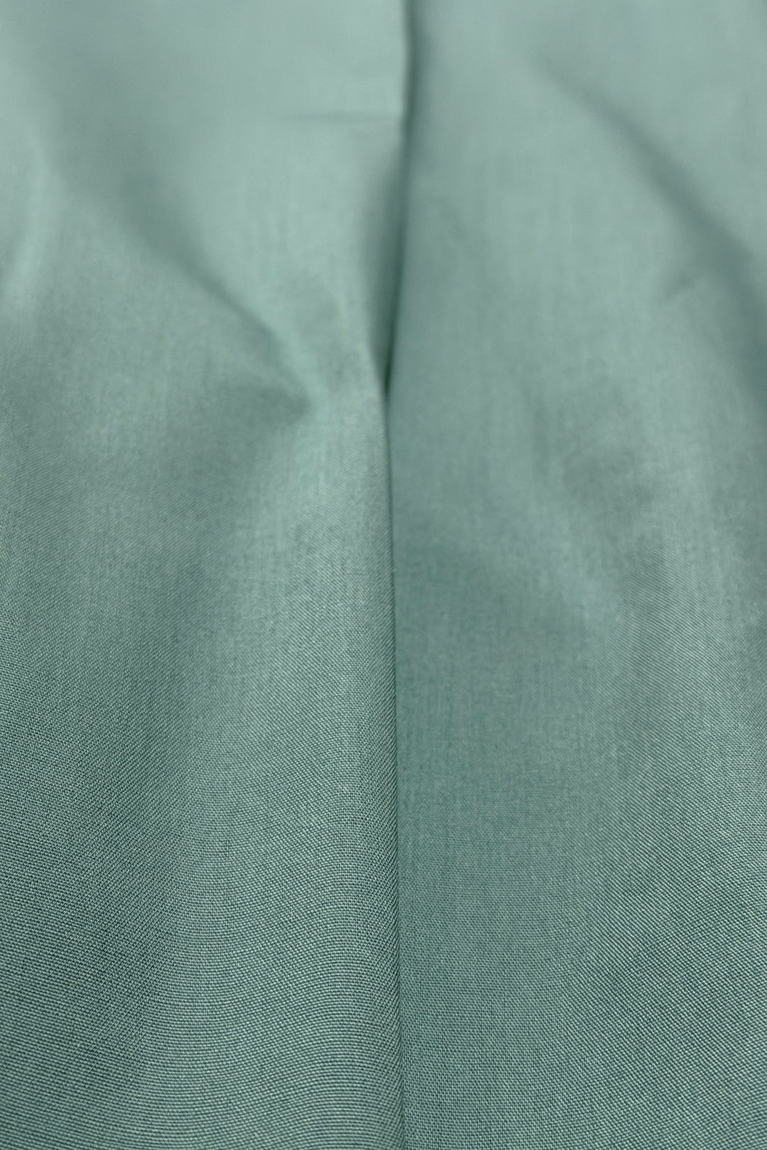 Teal pleated pants fabric detail