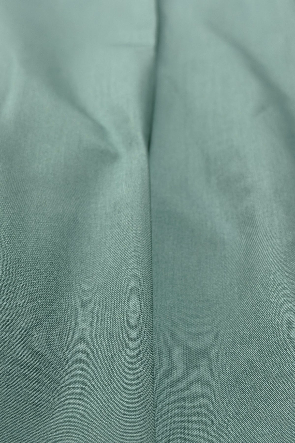 Teal pleated pants fabric detail