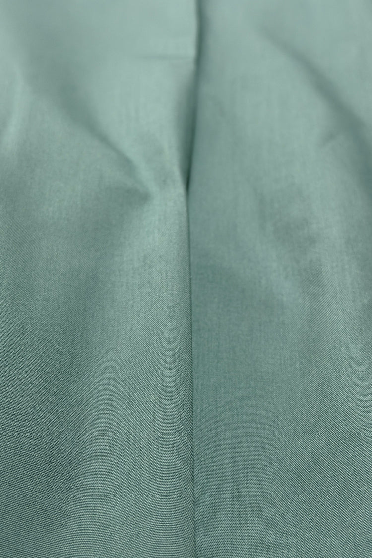 Teal pleated pants fabric detail
