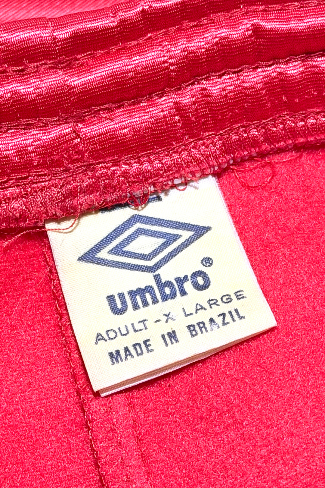Umbro red track pants tag