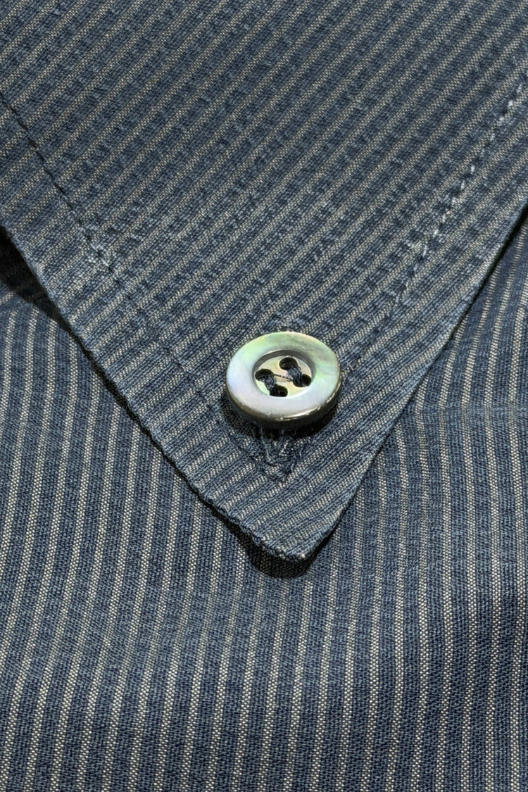 Mother-of-pearl button on button down collar